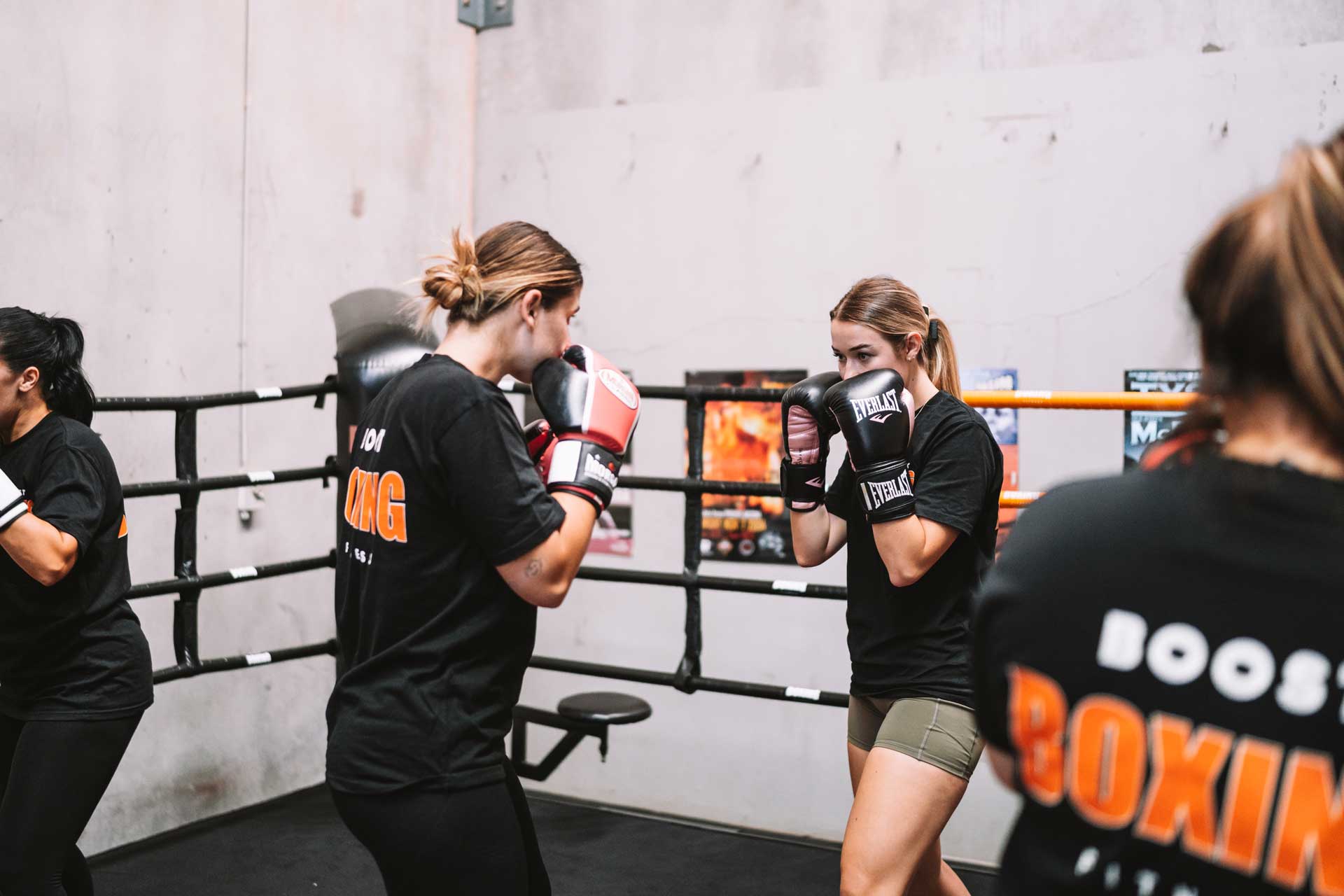Two females boxing training in ring