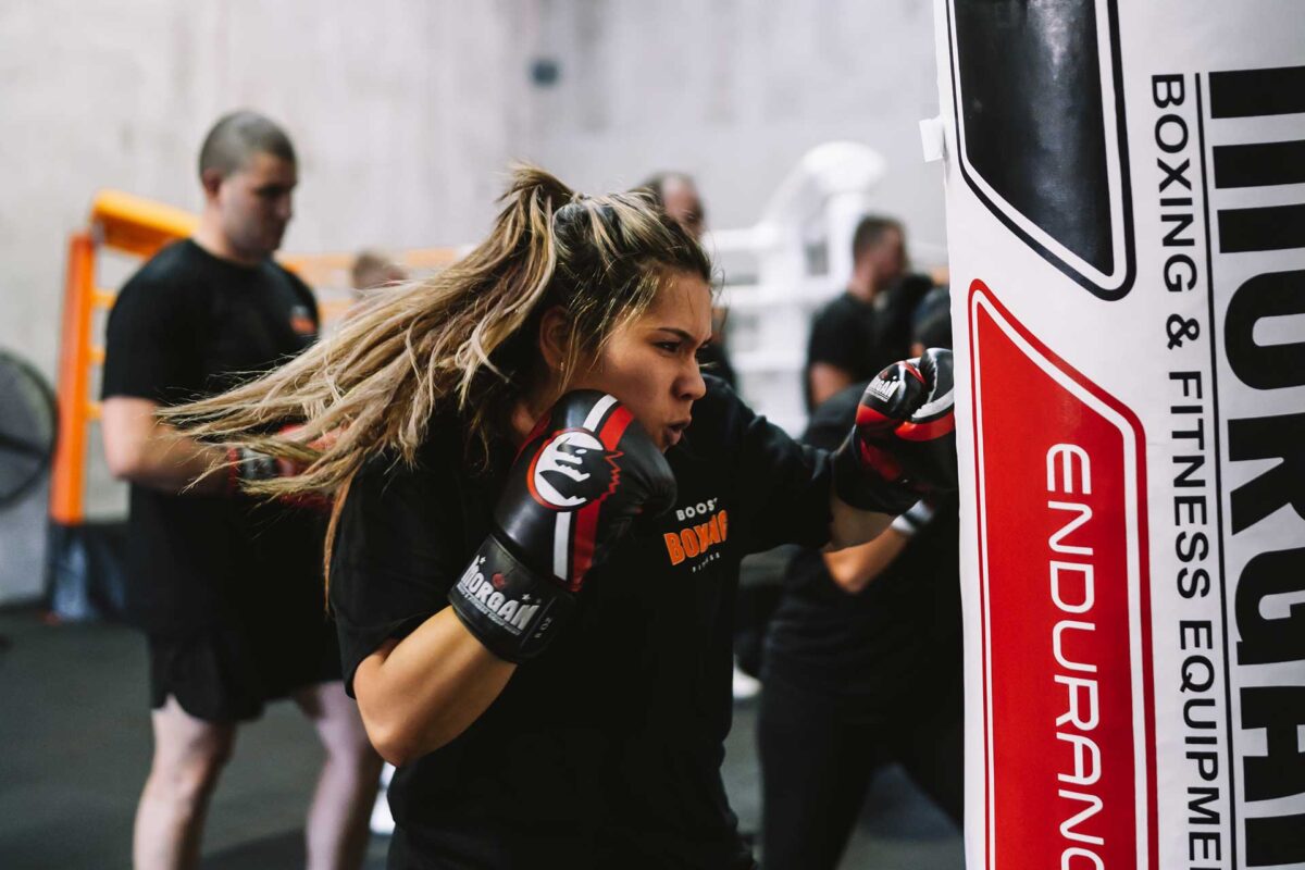 Female punching boxing bag